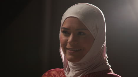 studio head and shoulders portrait of smiling muslim woman wearing hijab 2