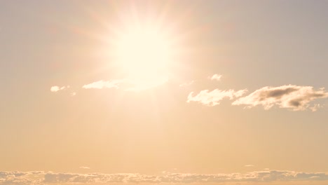 sun gradually setting behind clouds over time