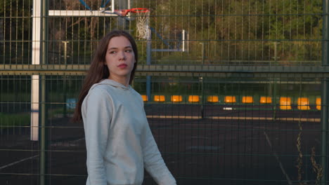 young woman standing on a basketball court