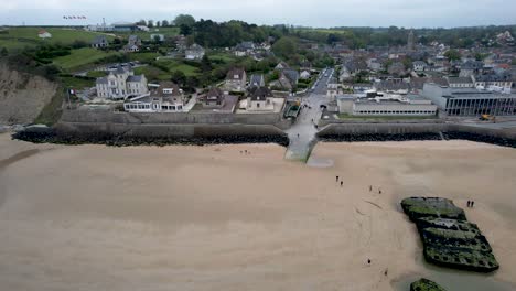 Vista-Panorámica-Aérea-De-Arromanches-Les-Bain,-Normandía,-Francia-Con-Bunkers-Ww2-En-La-Playa