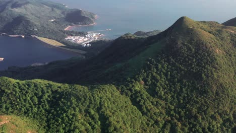 Aerial-Top-view-of-Tian-Tan-Buddha-and-Ngong-Ping-Village-Surrounding-Landscape,-Lantau-Island,-Hong-Kong