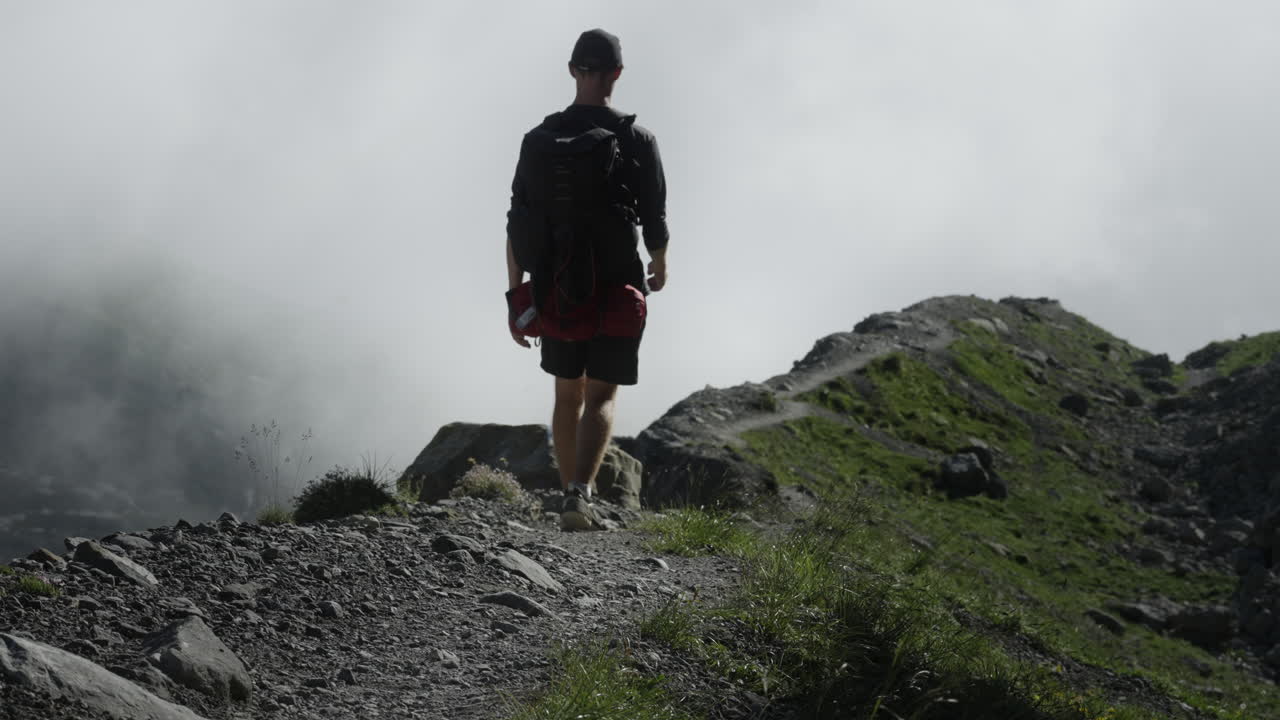 Hiker on a Mountain Trail in Fog