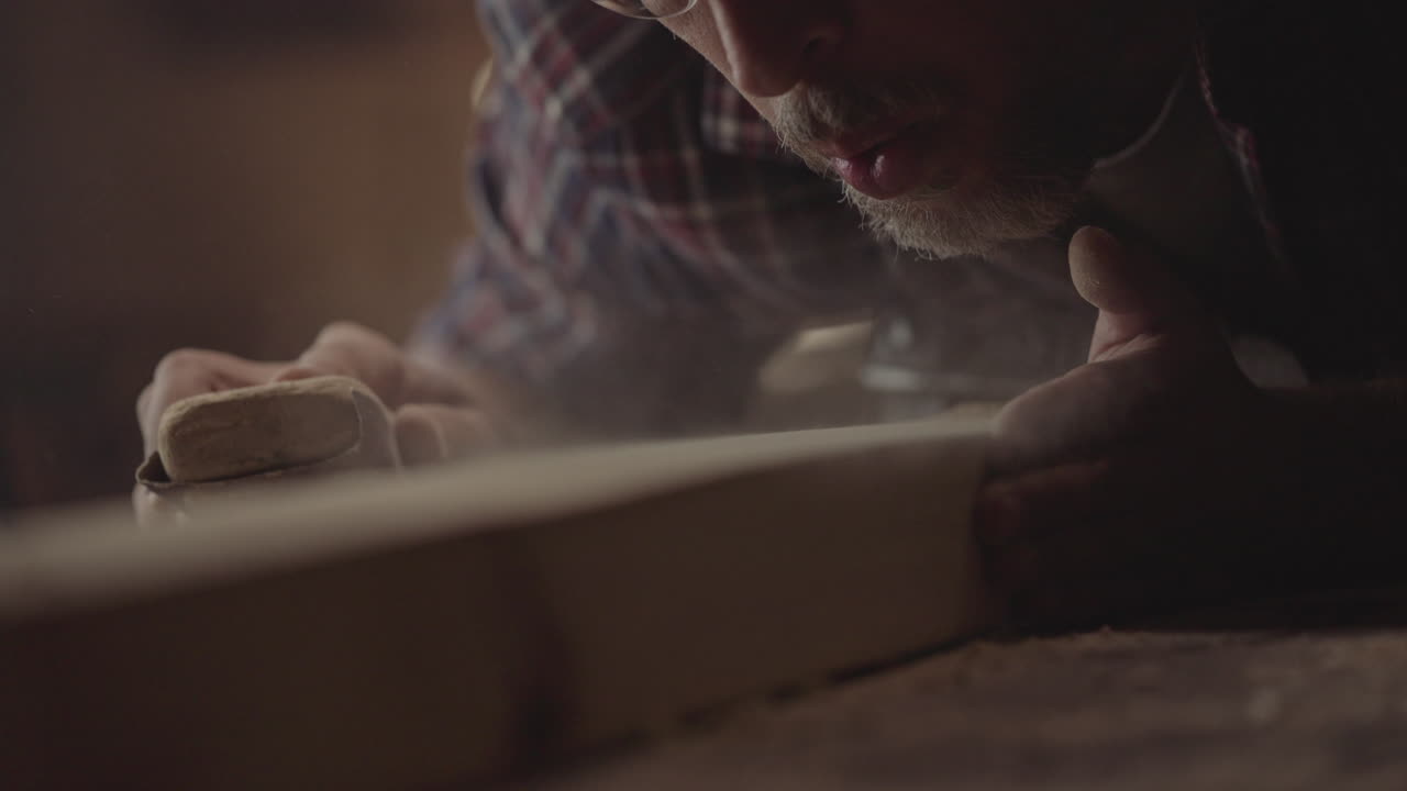 Woodworking and sanding a wooden plank