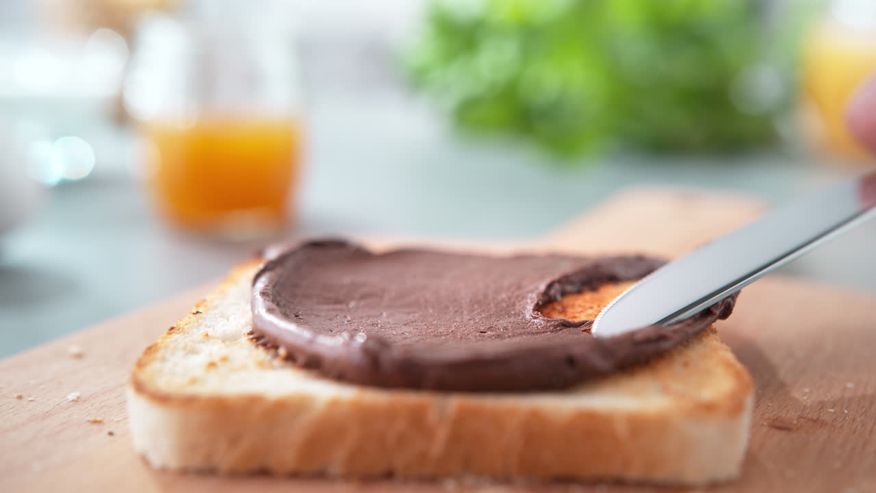 Spreading Chocolate Or Cocoa Butter On Lightly Toasted Bread With A Table Knife, Breakfast in Slow Motion