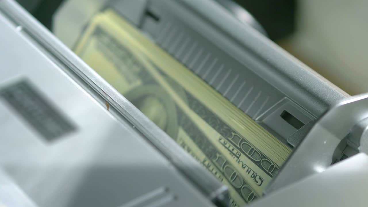Machine counter automatic calculates a large amount of Dollar banknotes in 4K Slow motion 60fps
