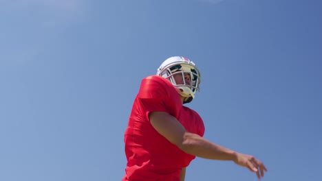 american football player throwing a ball