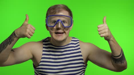 Emotional-man-tourist-in-underwater-mask-waving-hands,-striped-sailor-shirt
