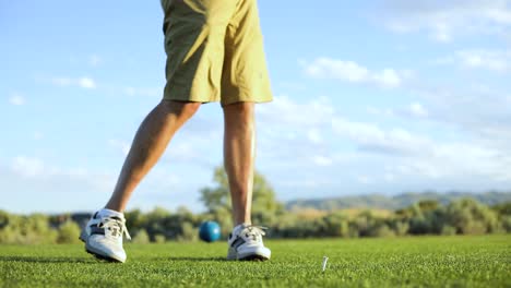 slo-mo shot of a man hitting a golf ball off a tee with his driver