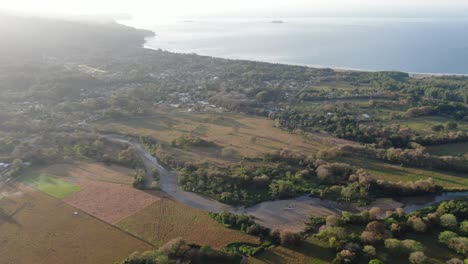 Costa-Rica-drone-view-showing-sea-green-forest-with-rivers-flowng-through-with-the-pacific-ocean-in-the-background