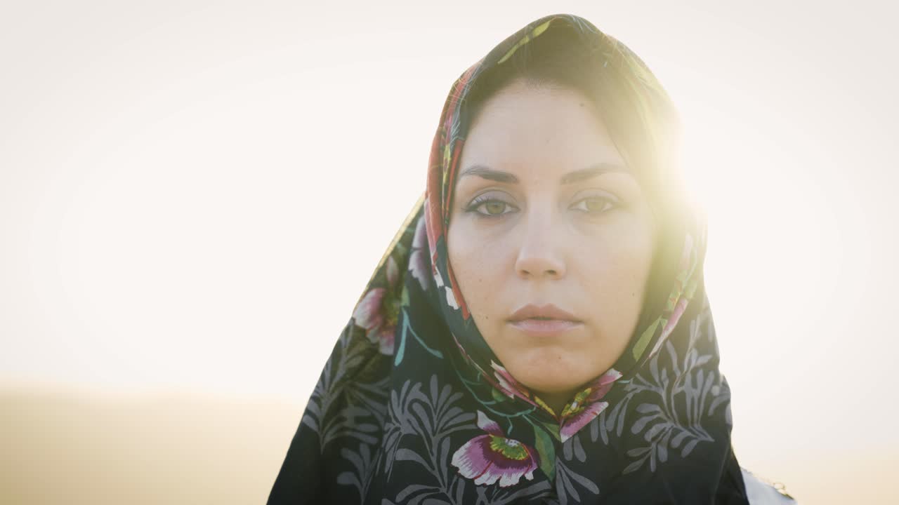 Portrait of a beautiful muslim woman in a hijab at sunset