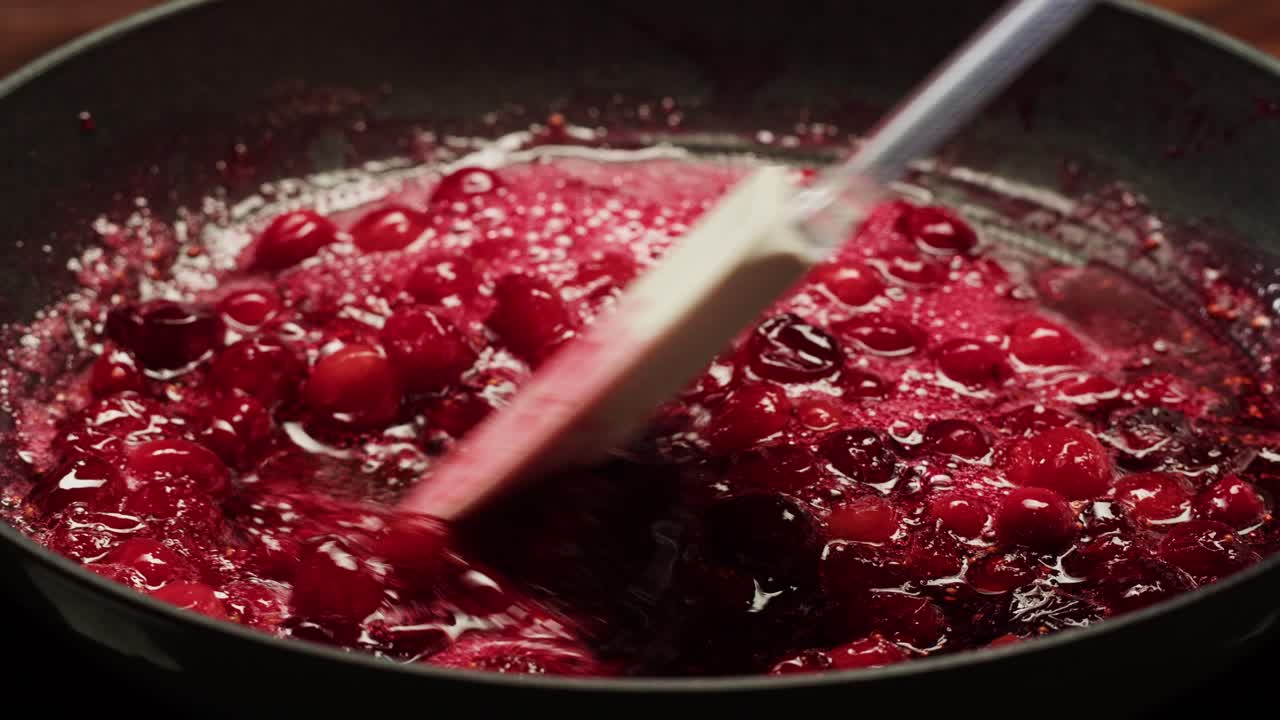 Frozen cranberries cooking for tea or jam, Background Close up of cranberry berries in on the kitchen, chef making dessert healthy pie.