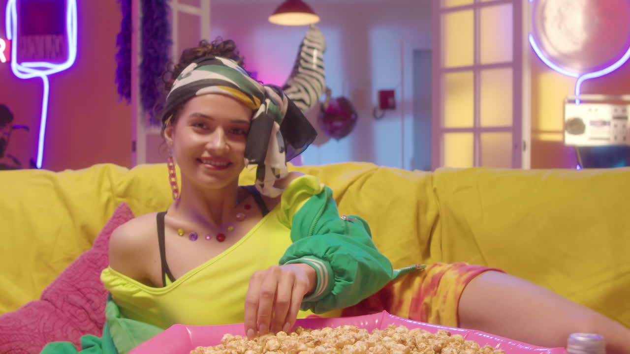 Woman Relaxing with Popcorn in a Colorful Party Setting