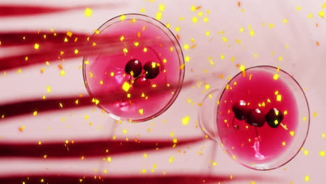 Animation-of-confetti-falling-and-cocktail-on-pink-background