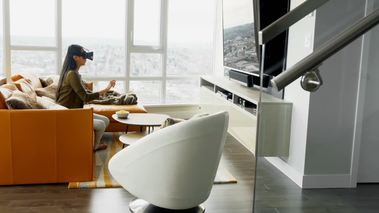 Woman using virtual reality headset in living room 4k