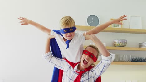 mother and son pretending to be superhero in living room 4k