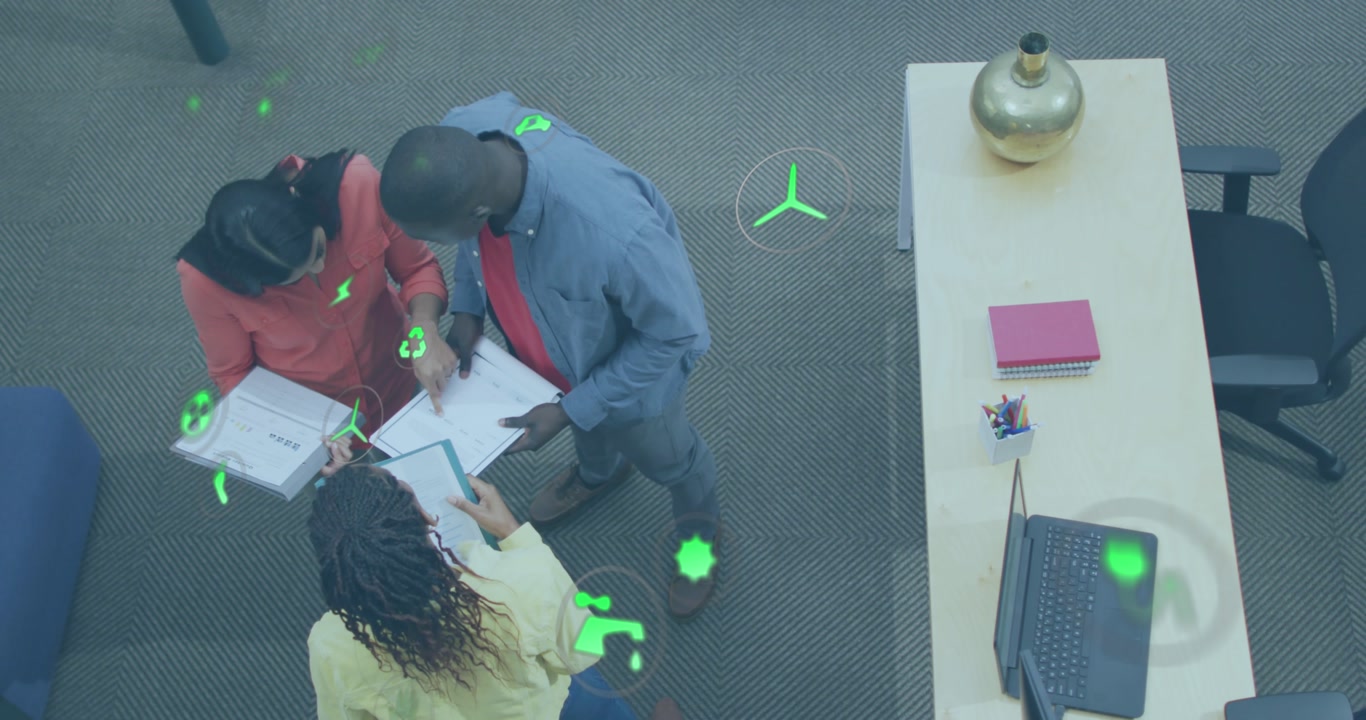 Animation of multiple icons, high angle view of diverse coworkers standing and discussing reports