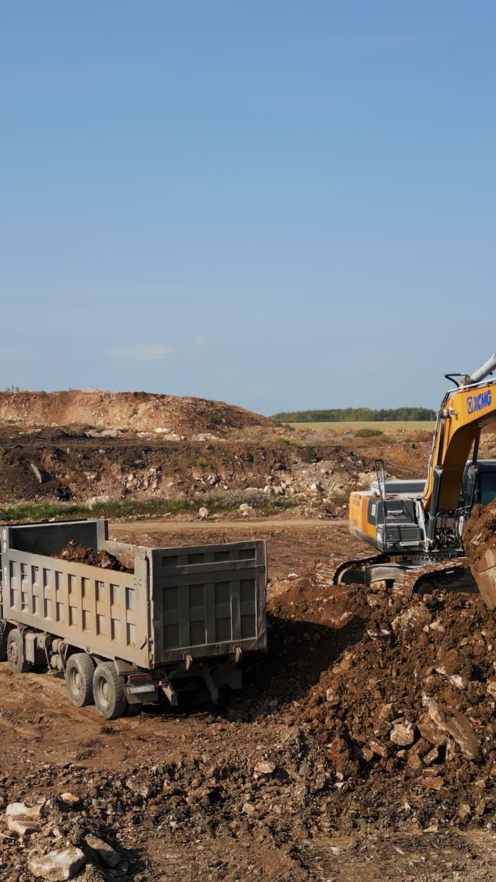 Excavator loading a dump truck at a construction site