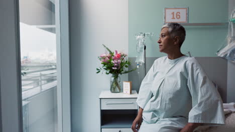 sad, woman and thinking at window in hospital