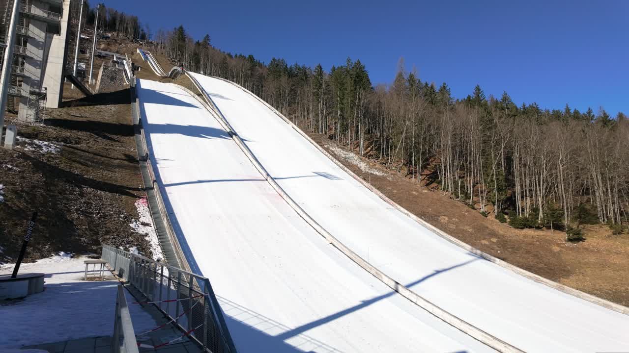 Exercising ski jumpers on the parallel flying hills in slow motion at Planica, Slovenia.