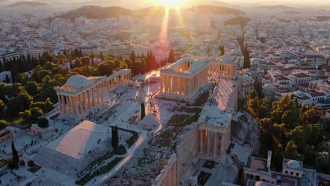 aerial video captures the acropolis at sunset, showcasing ancient ruins with a golden glow