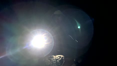 female in kaumana lava cave, shinning flashlight in dark hawaiian cave