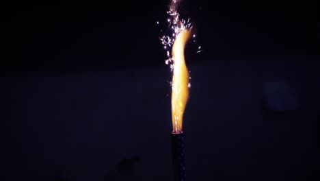 cinemagraph of sparks exploding on firework candle in the dark