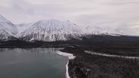 coniferous forest, mountains and lake in kluane national park, canada - drone shot