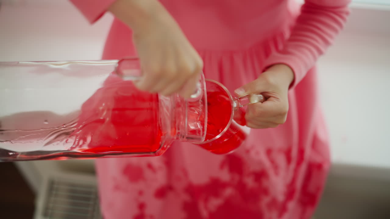 Child pouring red juice