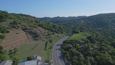 Aerial:-Cars-driving-on-rural-ROAD-NAVARRETE-in-Puerto-Plata,Dominican-Republic-during-summer