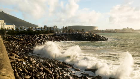 Waves-crash-on-black-rocky-beach-at-Cape-Town-Waterfront