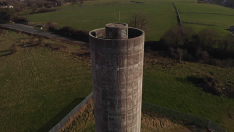 close-up shot of a tall water tower, highlighting its intricate architectural details and design.