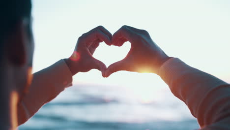 Hands,-heart-and-sun-with-couple-at-beach