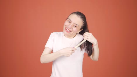 Woman-combing-her-hair.