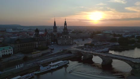 Smooth-aerial-top-view-flight-Sunset-city-Dresden-Church-Cathedral-Bridge-River