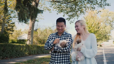 Young-Couple-Walking-With-Puppies