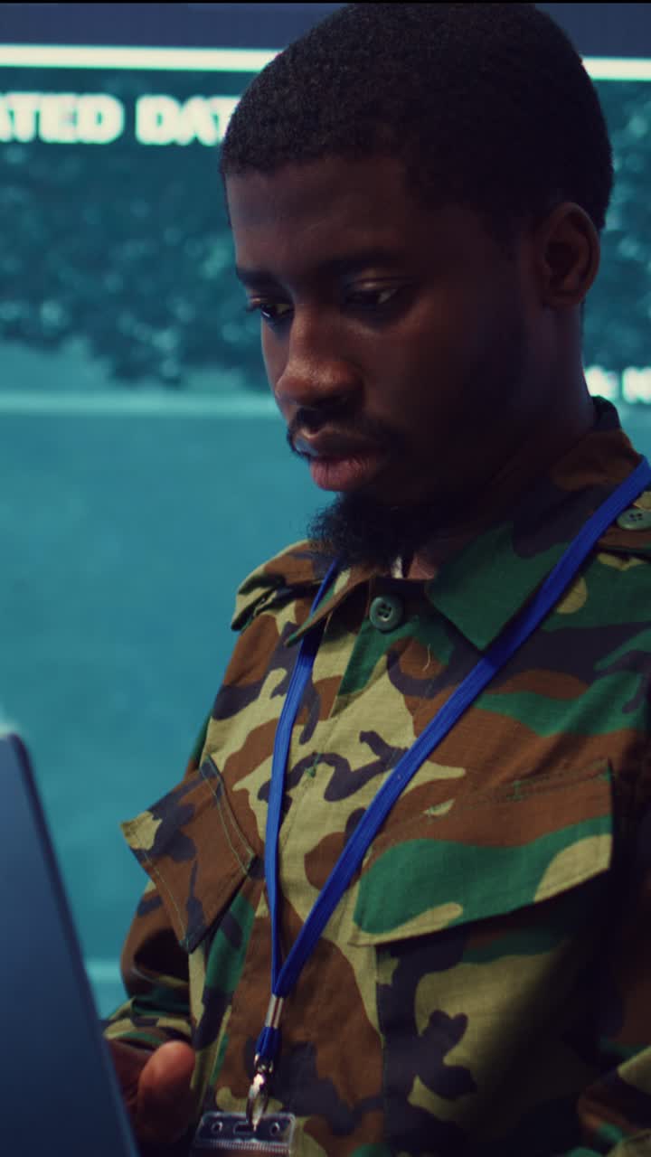 Soldier in Camouflage Uniform Working on Laptop in Control Room
