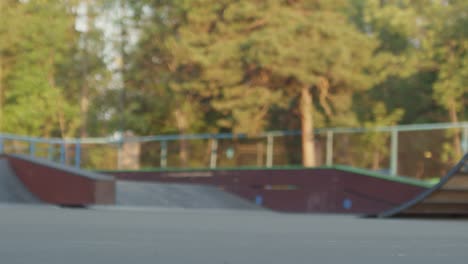 Camera-Focuses-The-Skateboard-Trick-In-The-Park