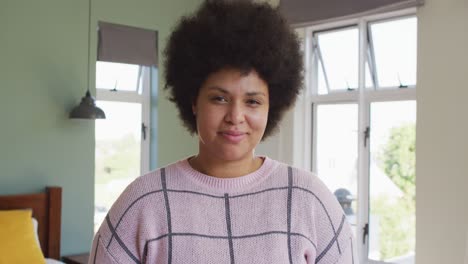 portrait of happy biracial woman smiling and looking at camera