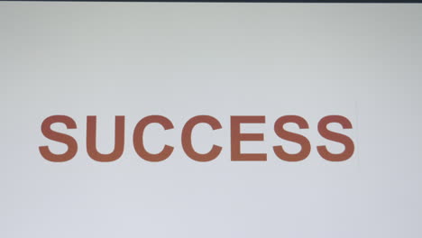 Cursor-moving-to-the-right-revealing-letters-from-a-capital-letter-S-to-complete-the-word-SUCCESS-as-a-person-types-on-a-keyboard-or-making-a-text-message