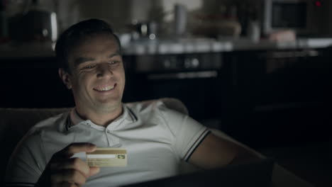 happy businessman making online shopping at night time.