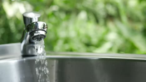 water pouring from a faucet tap slow motion