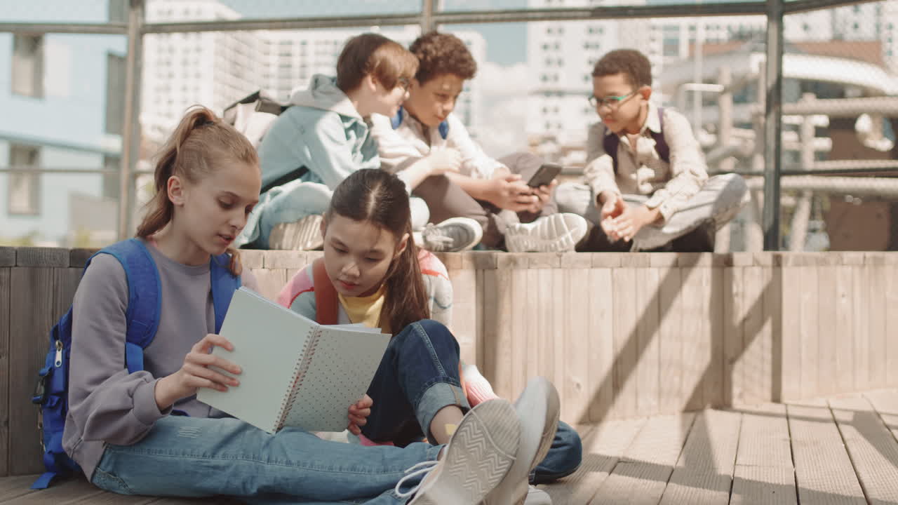 Group of School Kids Resting Outdoors in Summer