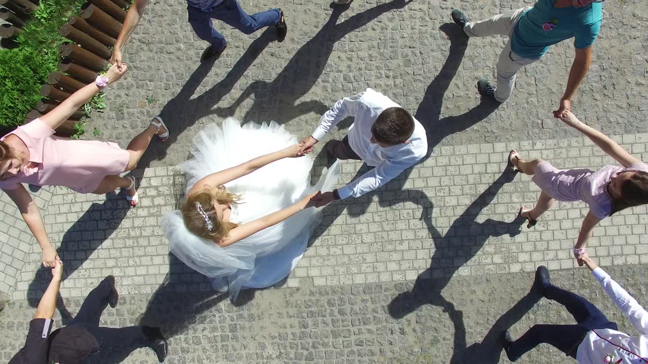 Lovely Couple On Wedding Day. VINNITSA, UKRAINE - AUGUST 2016: Aerial shot of a group people at wedding outdoor. High angle view.
