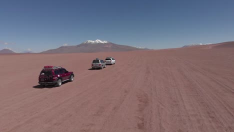expedition vehicles drive onto atacama desert near juriques volcano
