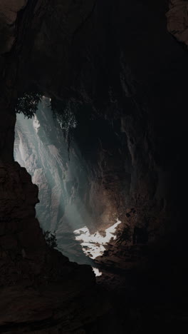 a deep dark cave with light shining in