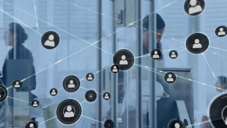 Animation-of-network-of-connections-with-icons-over-diverse-people-in-office