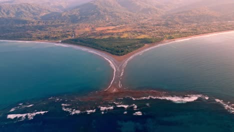 breathtaking aerial view captures the iconic "whale's tail" sand formation at marino ballena national park in uvita, costa rica, illuminated by the serene golden light of sunrise