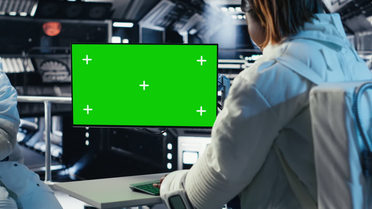 Team of cosmonauts calibrating starship sensors using isolated screen monitor