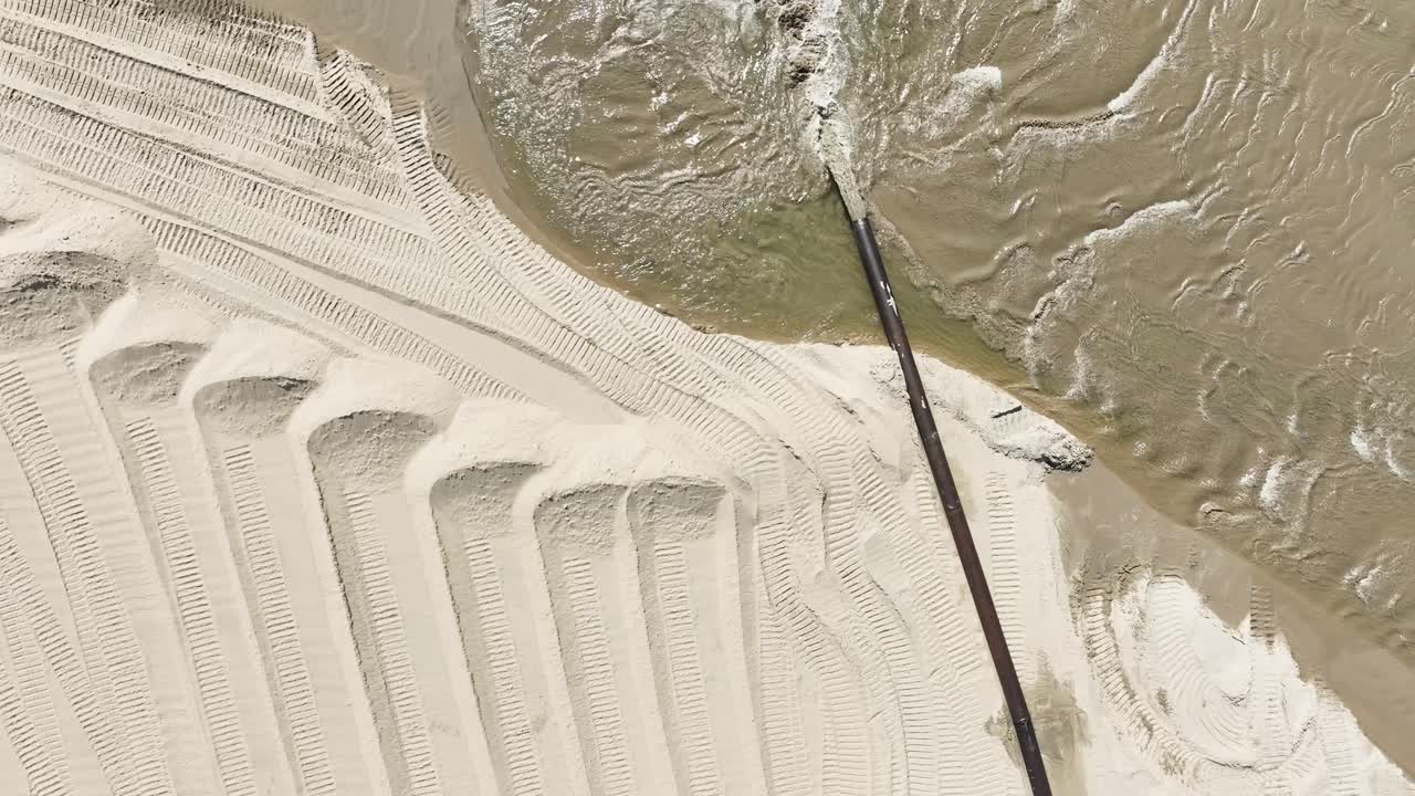 Spinning over water gushing from a dredge pipe