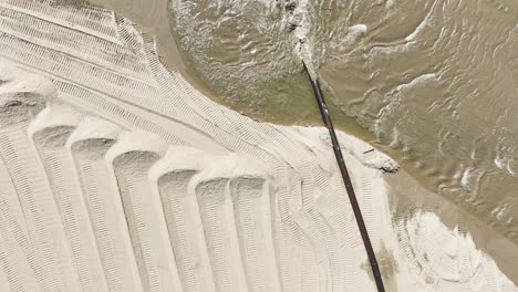 spinning over water gushing from a dredge pipe